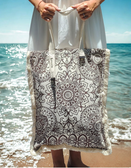 Woman wearing the black and white mandala long canvas bag at the beach