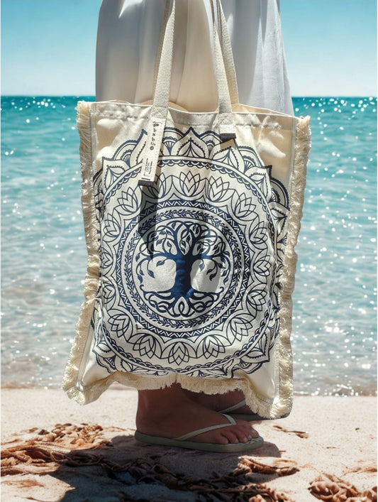 Woman wearing the black and white Tree of Life long canvas bag at the beach