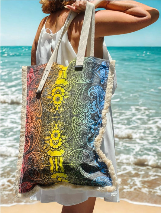 Woman wearing the multicolour ethnic flower long canvas bag at the beach