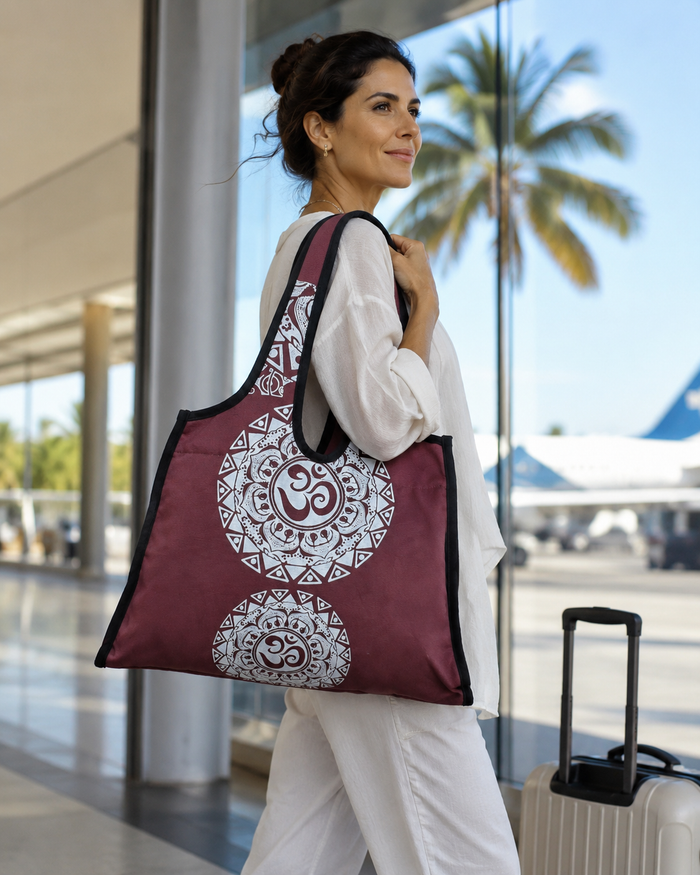 Woman carrying the burgundy Aum mandala canvas bag at a train station