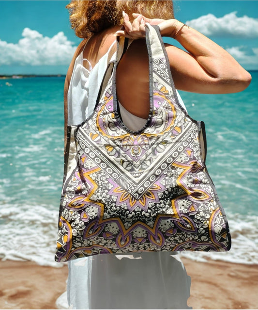 Woman wearing the purple mandala canvas bag at the beach