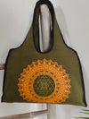 Boho Spirit canvas bag, Sri Yantra print in green and gold, flat lay